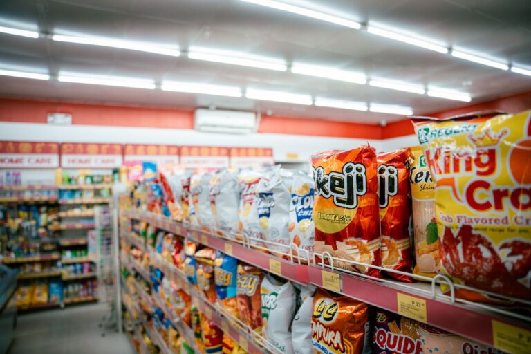 Grocery products lined up on supermarket shelves