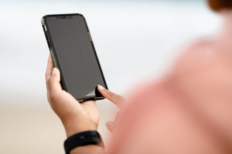 A person holding a smartphone in one hand